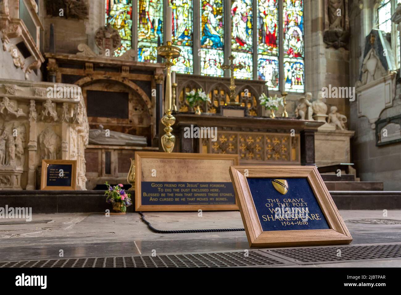 The grave of the poet William Shakespeare seen within the roped area and located inside Holy Trinity Church at Stratford upon Avon. Stock Photo