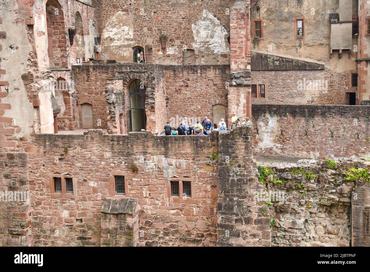 Heidelberg, Germany - June 2022: Tourist group standing in historic Heidelberg castle Stock Photo
