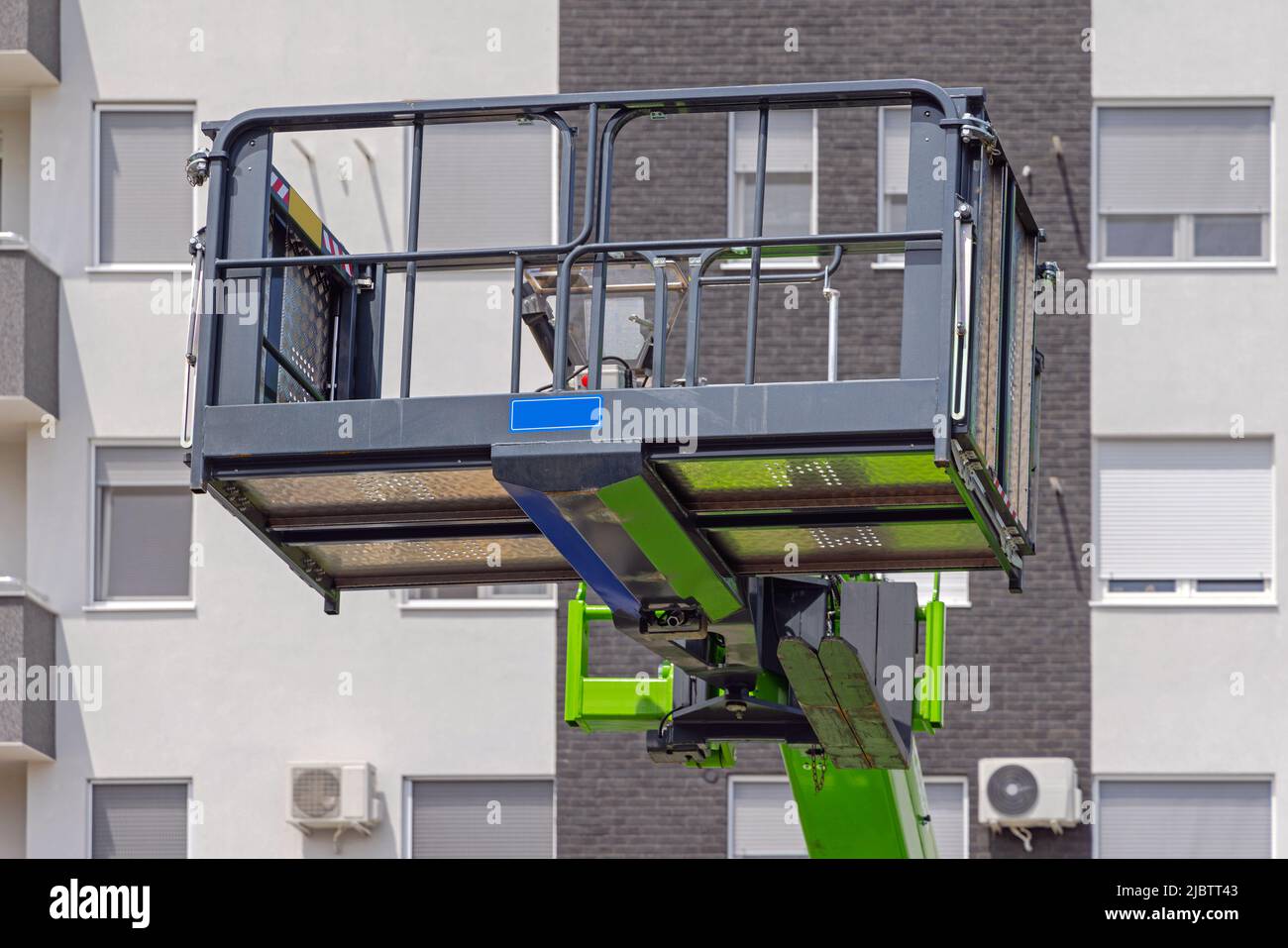 Forklift Attachment Platform Aerial Work at Building Exterior Stock Photo