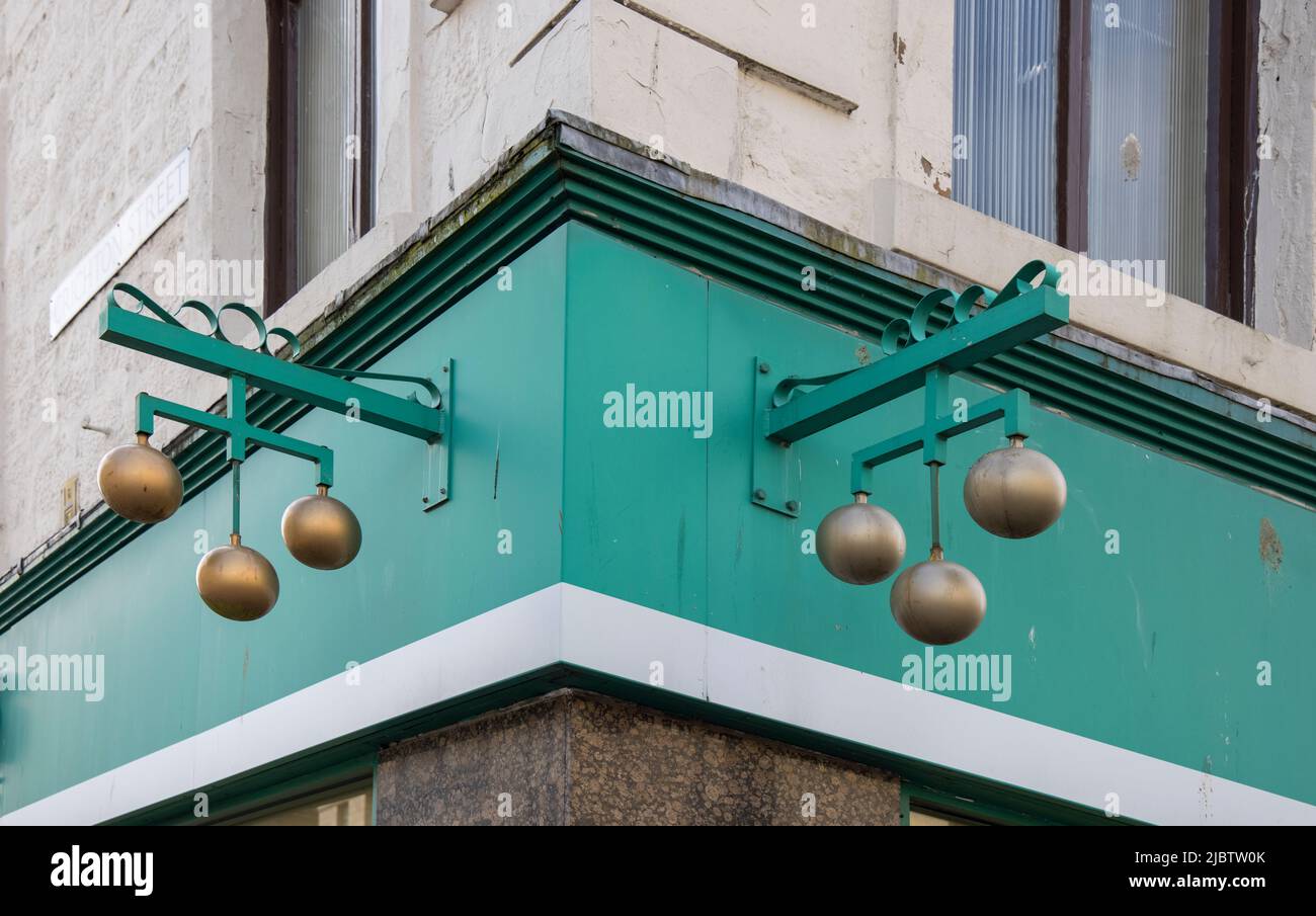 the brass balls of a pawn shop in central dundee scotland Stock Photo