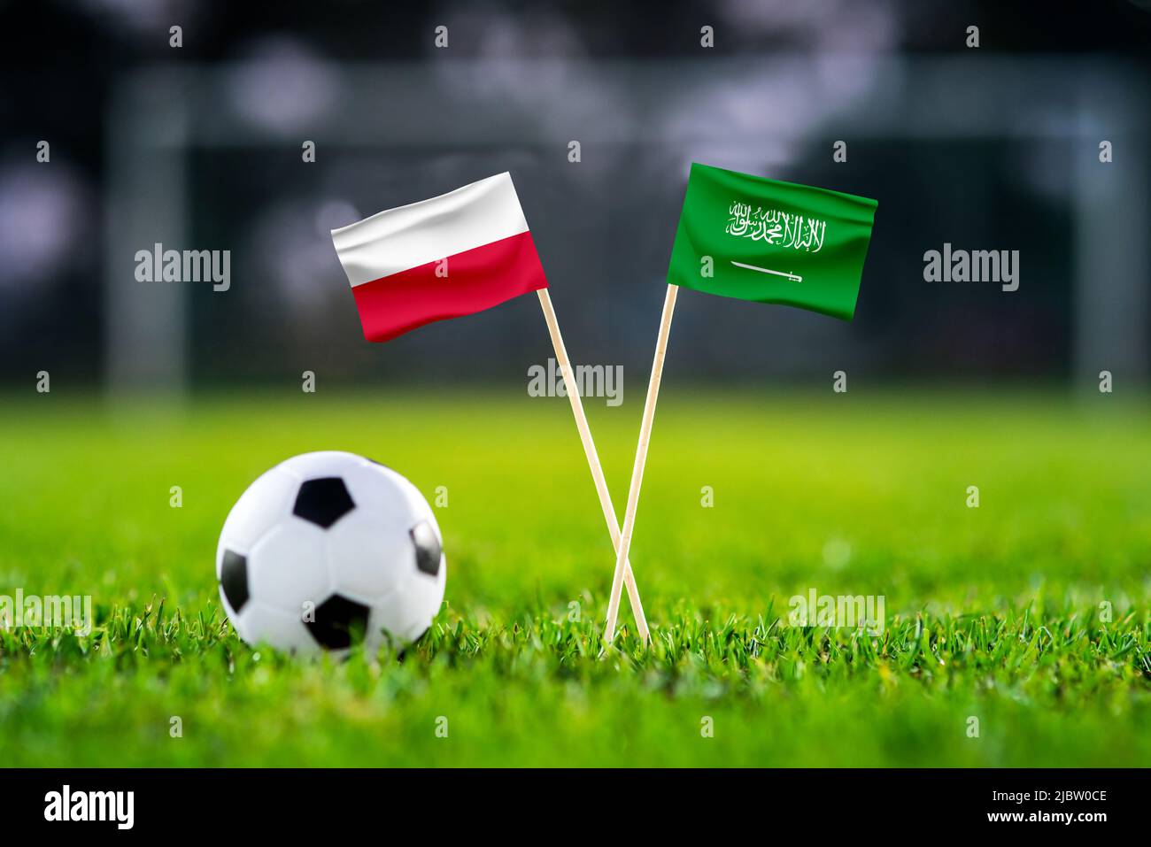 Poland vs. Saudi Arabia, Education City, Football match wallpaper, Handmade national flags and soccer ball on green grass. Football stadium in backgro Stock Photo