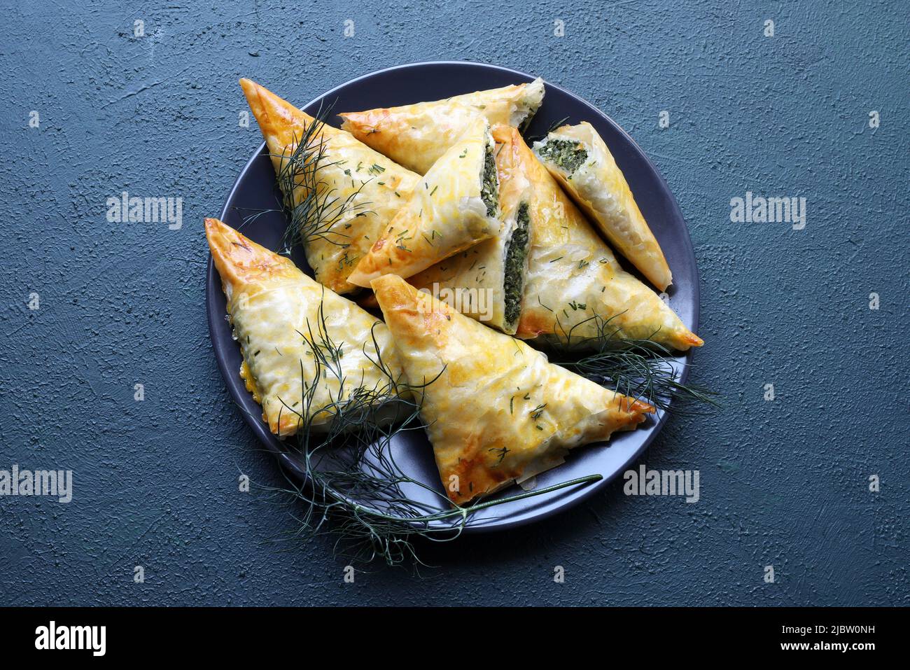 Traditional Greek cuisine. Spanakopita, crispy phyllo pastry triangles