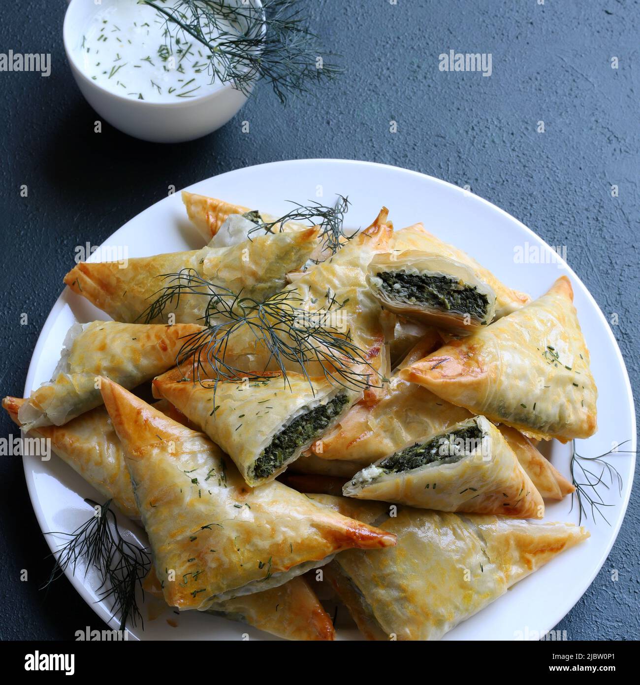 Traditional Greek cuisine. Spanakopita, crispy phyllo pastry triangles