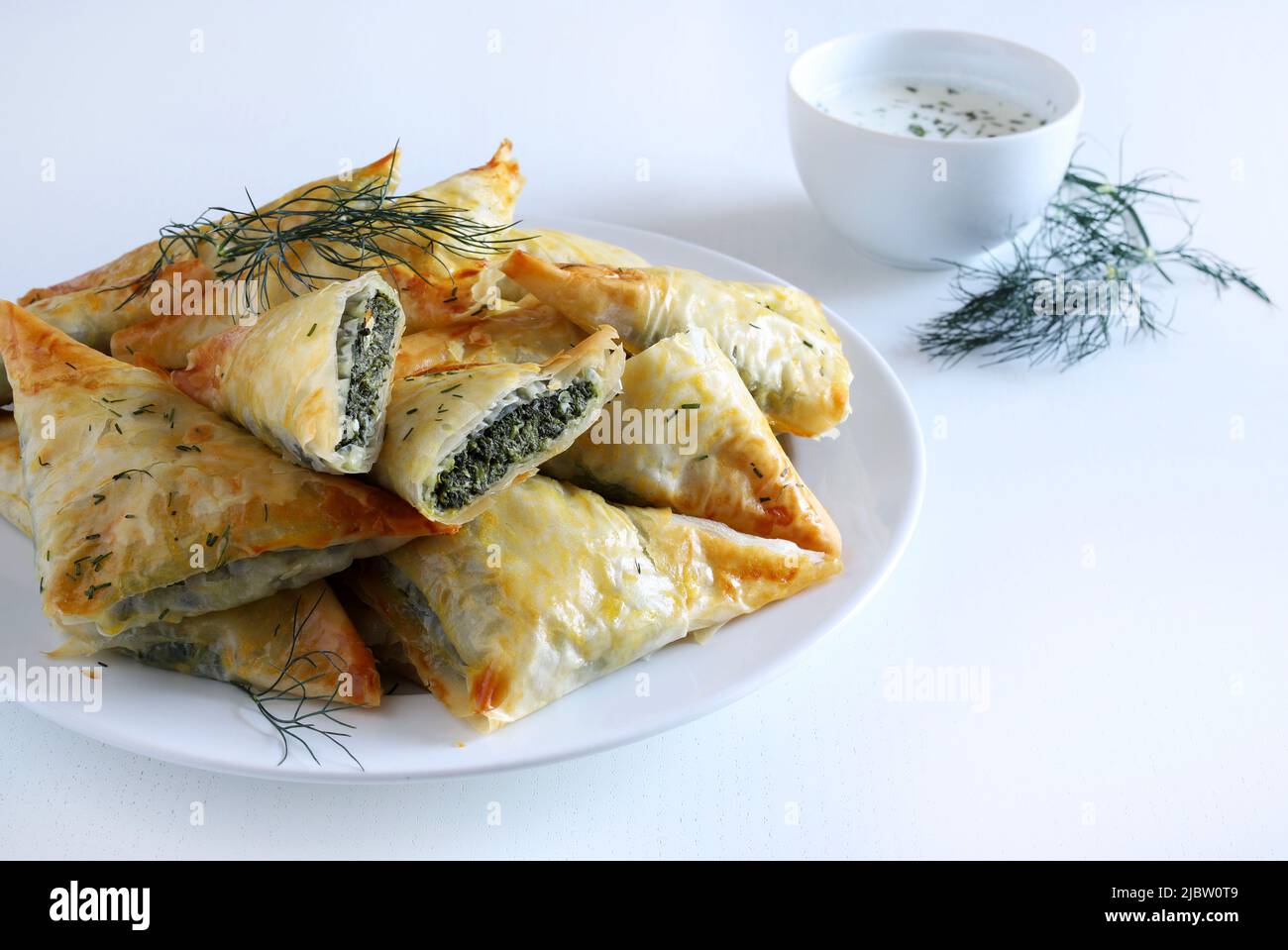 Traditional Greek cuisine. Spanakopita, crispy phyllo pastry triangles