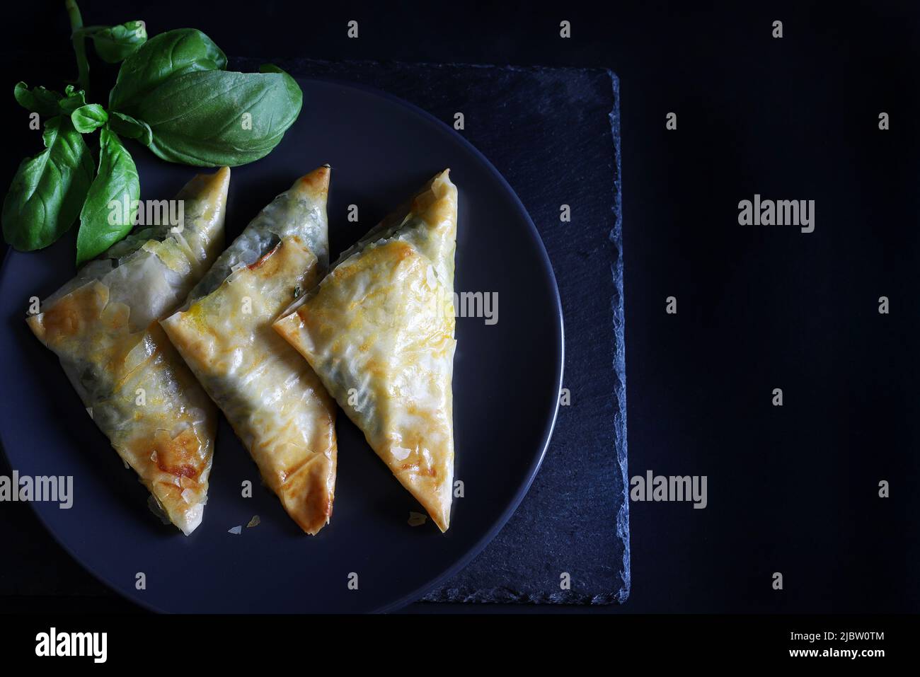 Spanakopita, crispy phyllo pastry triangles with spinach, feta and dill