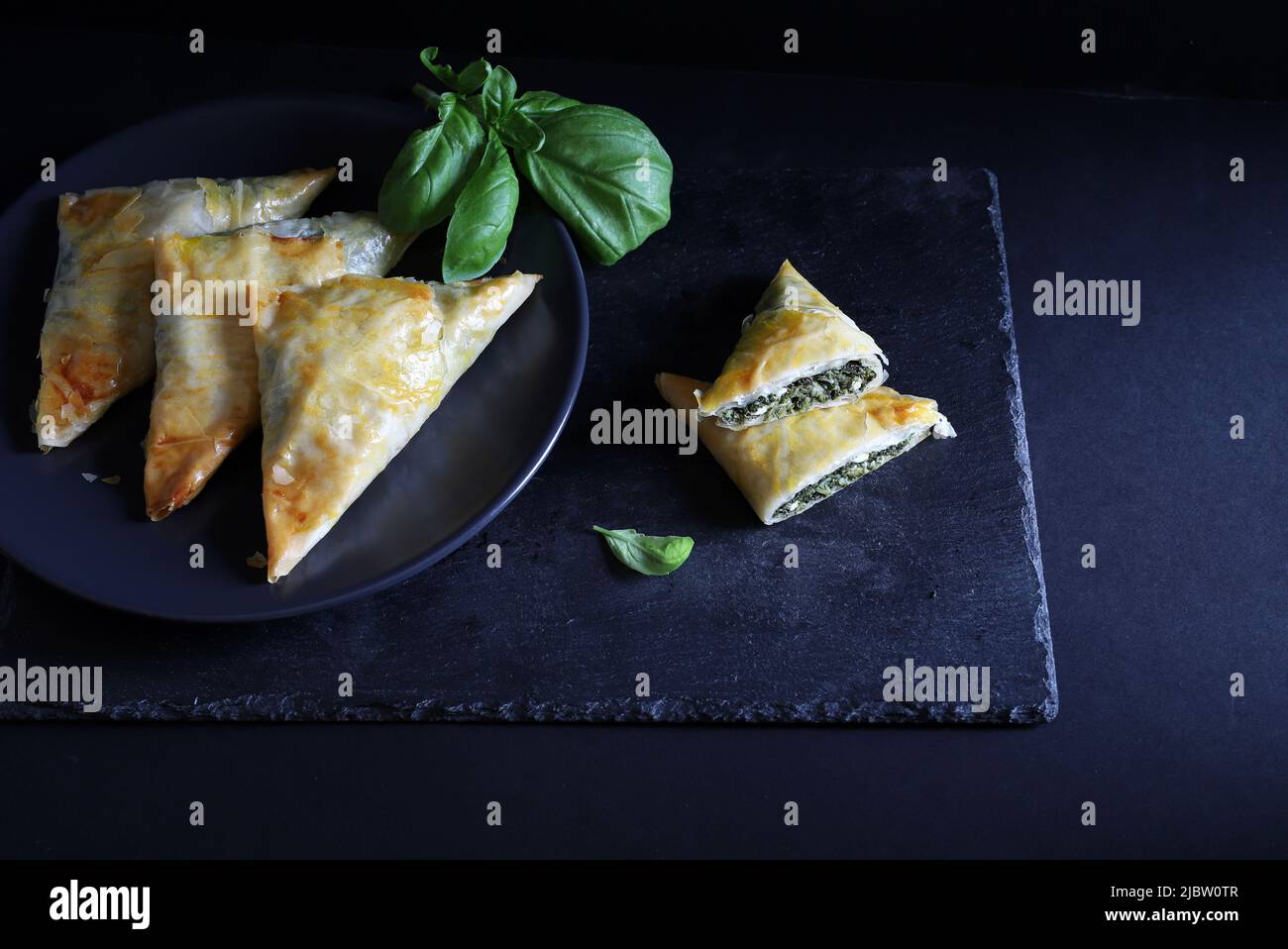 Spanakopita, crispy phyllo pastry triangles with spinach, feta and dill