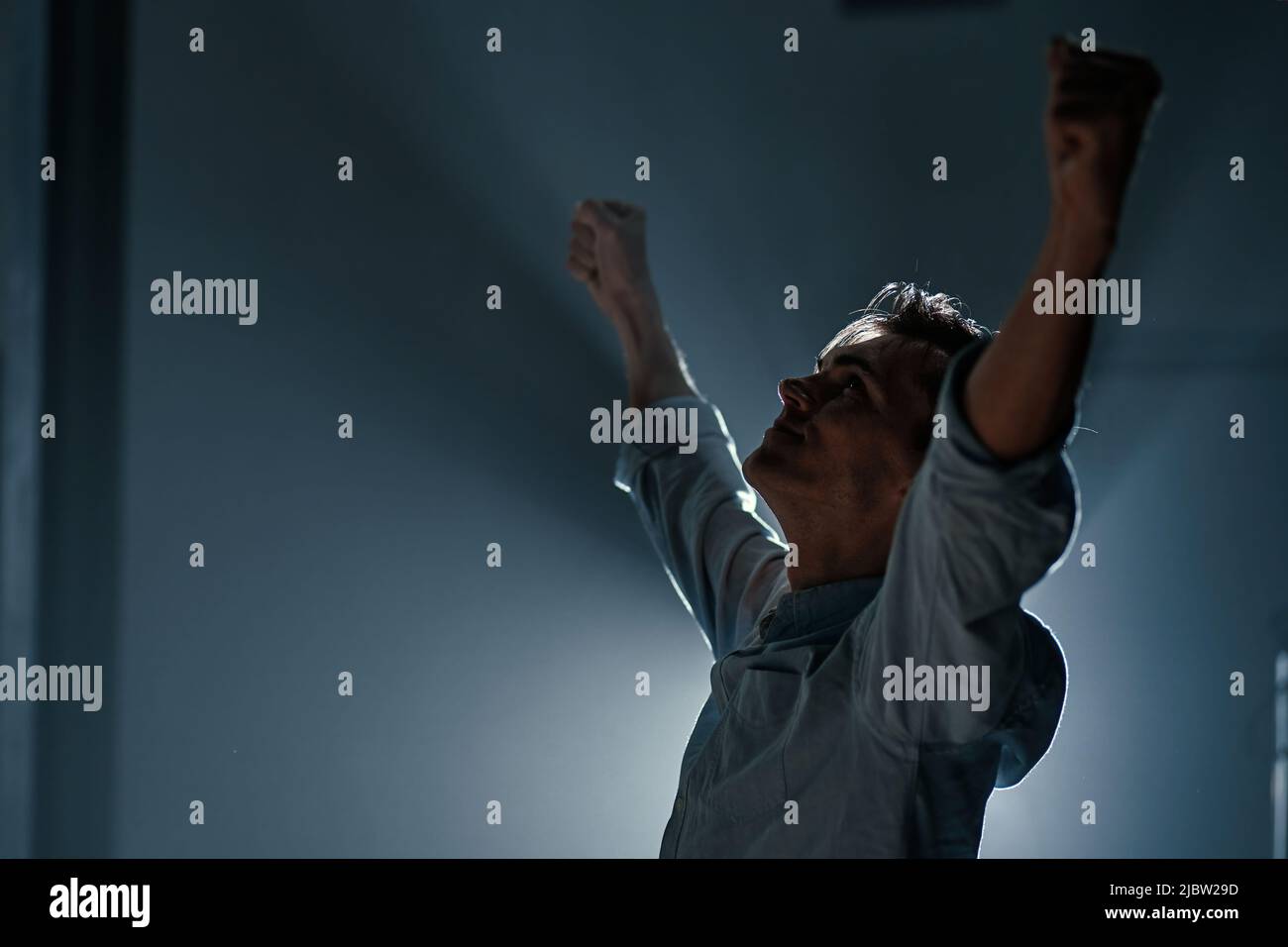 tired young businessman stretching during night work. Stock Photo