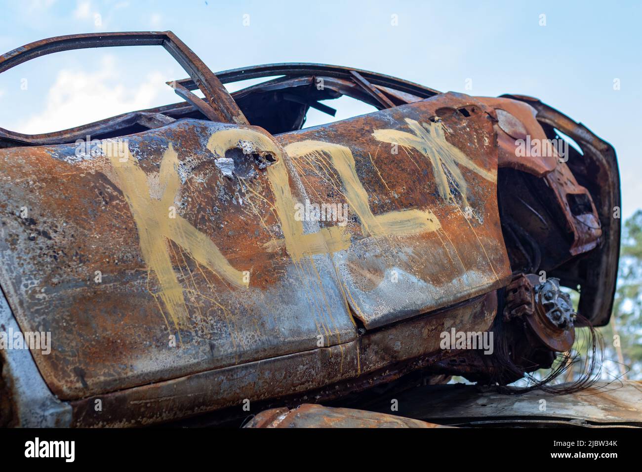 The car was completely destroyed by fire. Abandoned, burnt and rusty