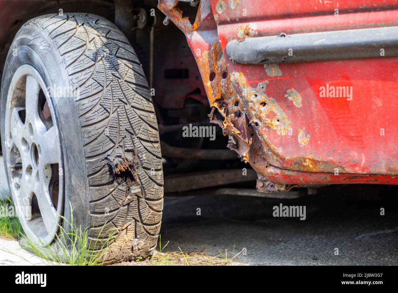 Flat car tire closeup. Shot through the wheel by the police while