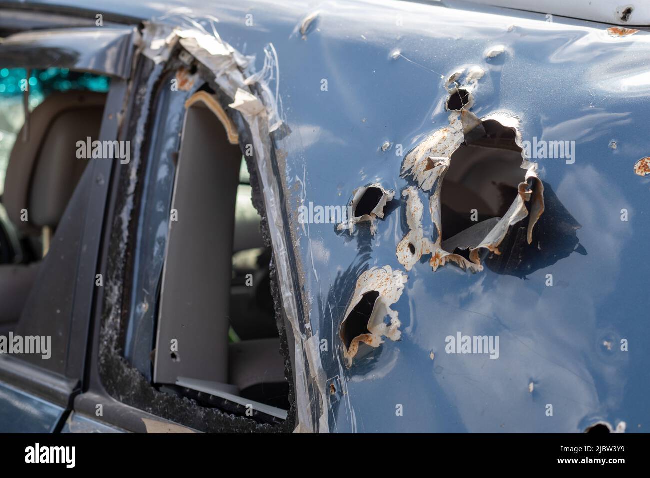 Car riddled with bullets. War of Russia against Ukraine. A car of ...