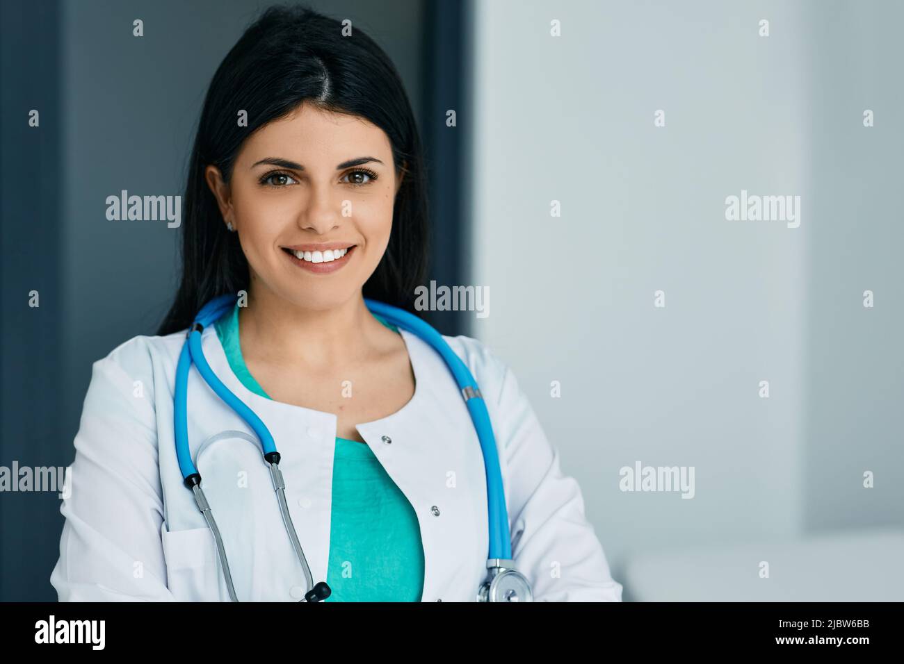 General practitioner. Smiling female physician wearing medical uniform