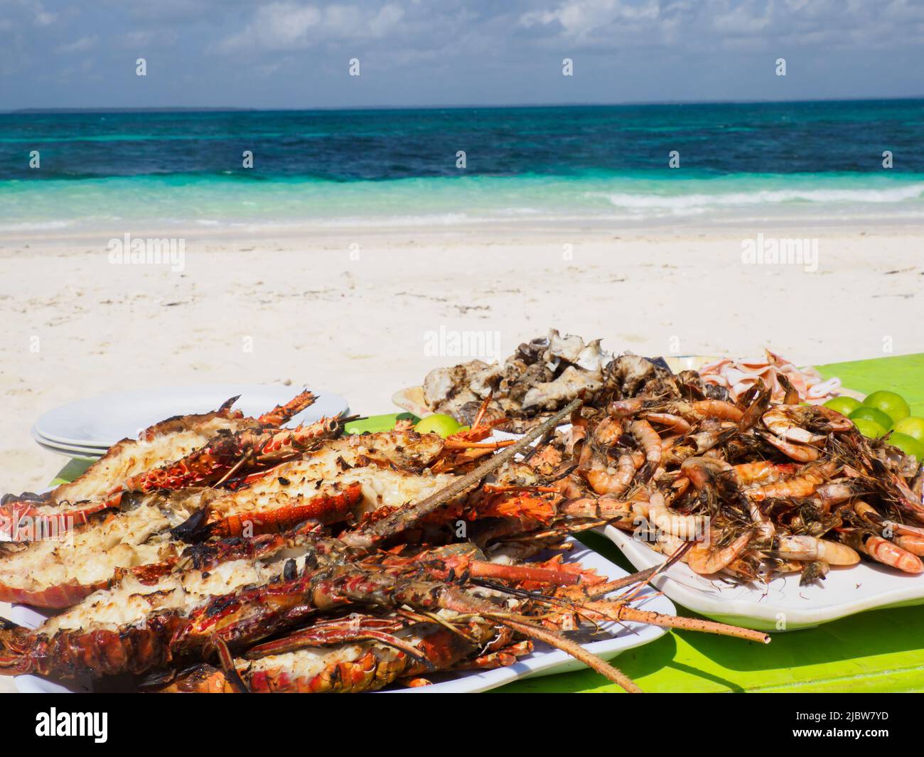 Grilled seafood served during a Blue Safari to sandbank in Menai Bay with beautiful sandy beach and lazure water, Zanzibar archipelago, Africa, Zanzib Stock Photo