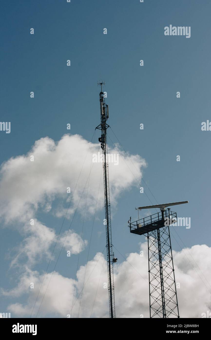 Up view. Tower with TV, radio, internet antennas. Providing modern communications. Stock Photo