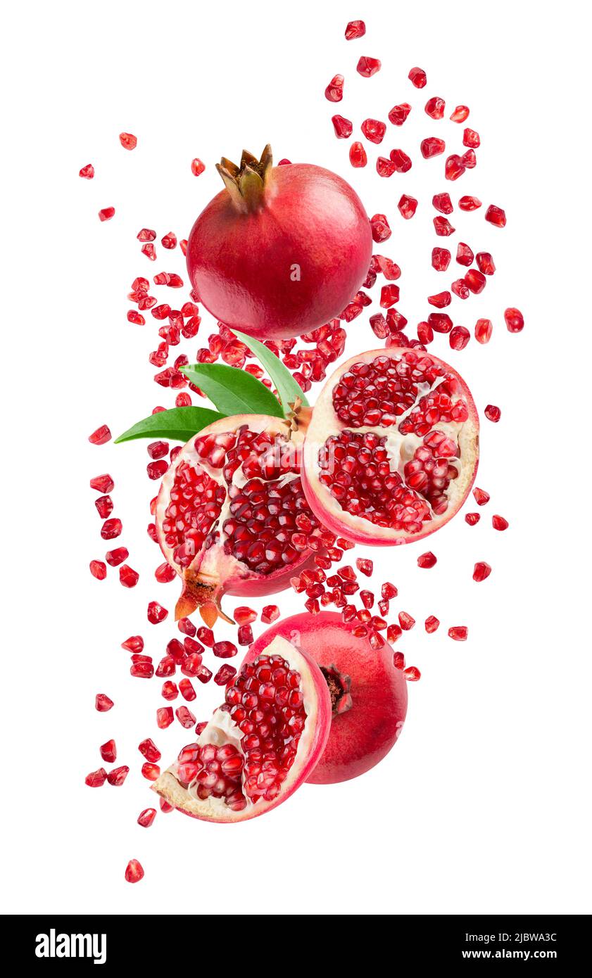 falling pomegranates with leaves isolated on a white background with clipping path. Stock Photo