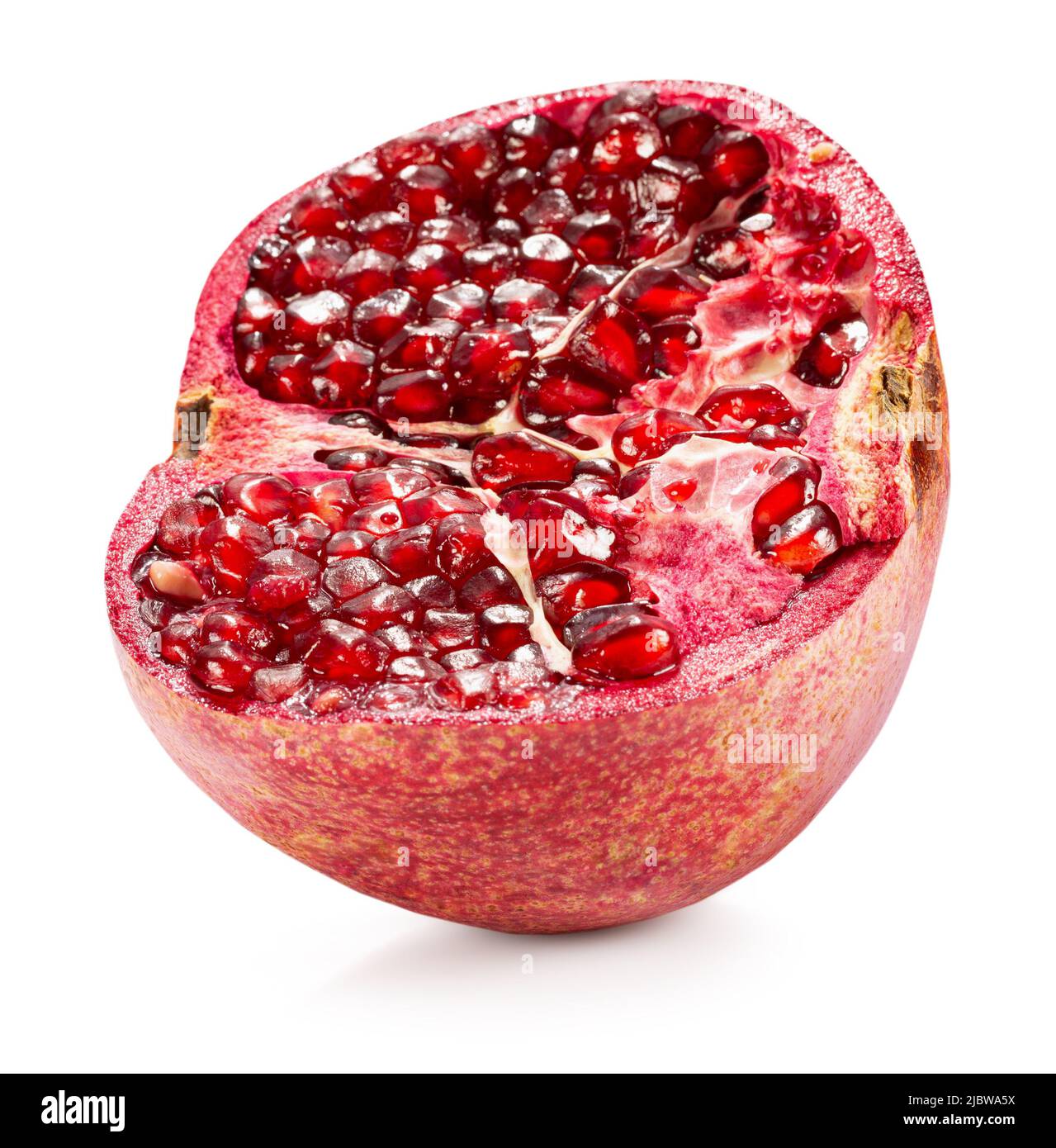 half of pomegranate with red seeds isolated on a white background with clipping path. Stock Photo