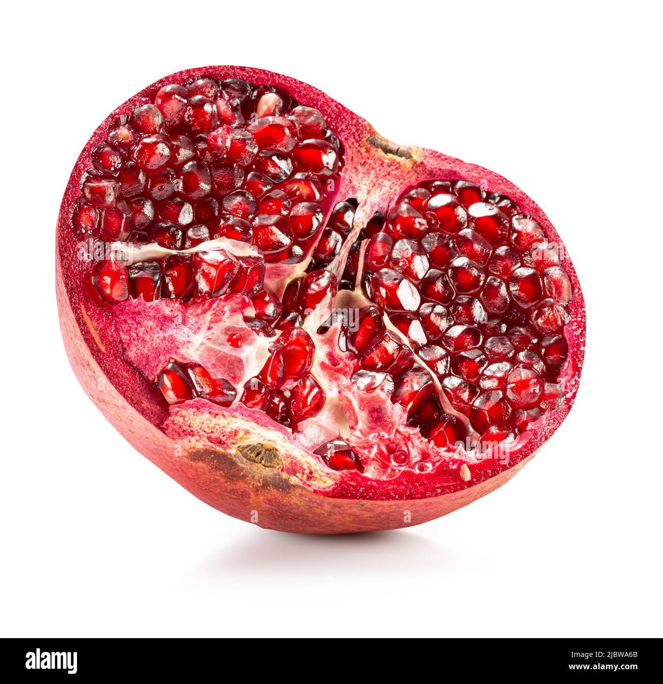 half of pomegranate with red seeds isolated on a white background with clipping path. Stock Photo