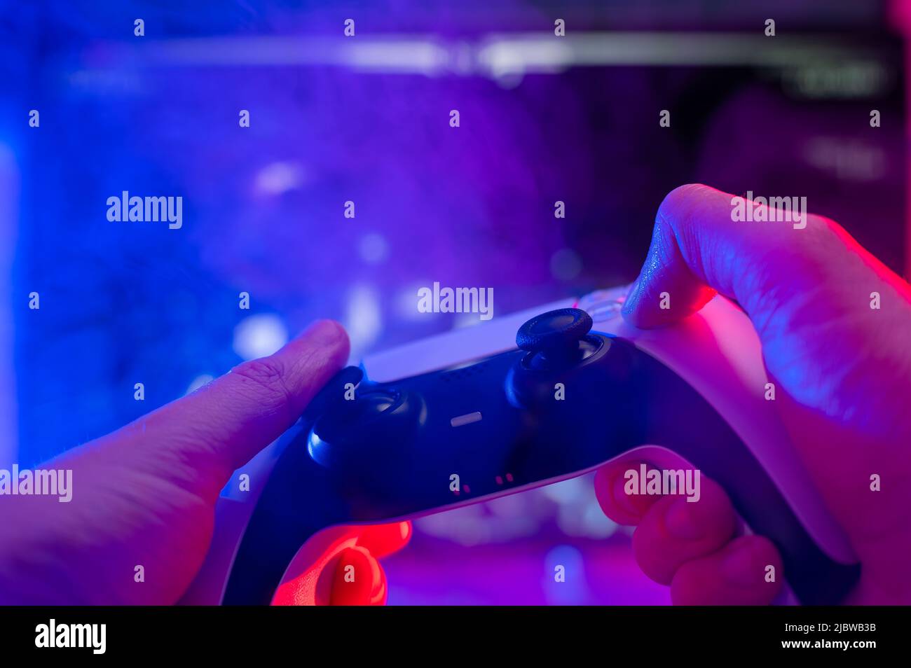 Joystick in the hands of a gamer on a technological background. Neon ...