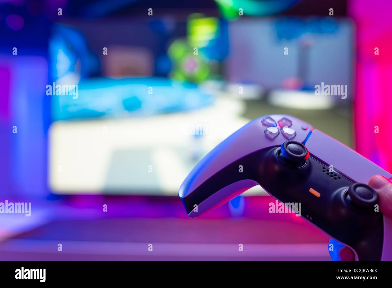 Modern Devic's Gamepad on a technological background. Neon glow. Close-up. There are ...