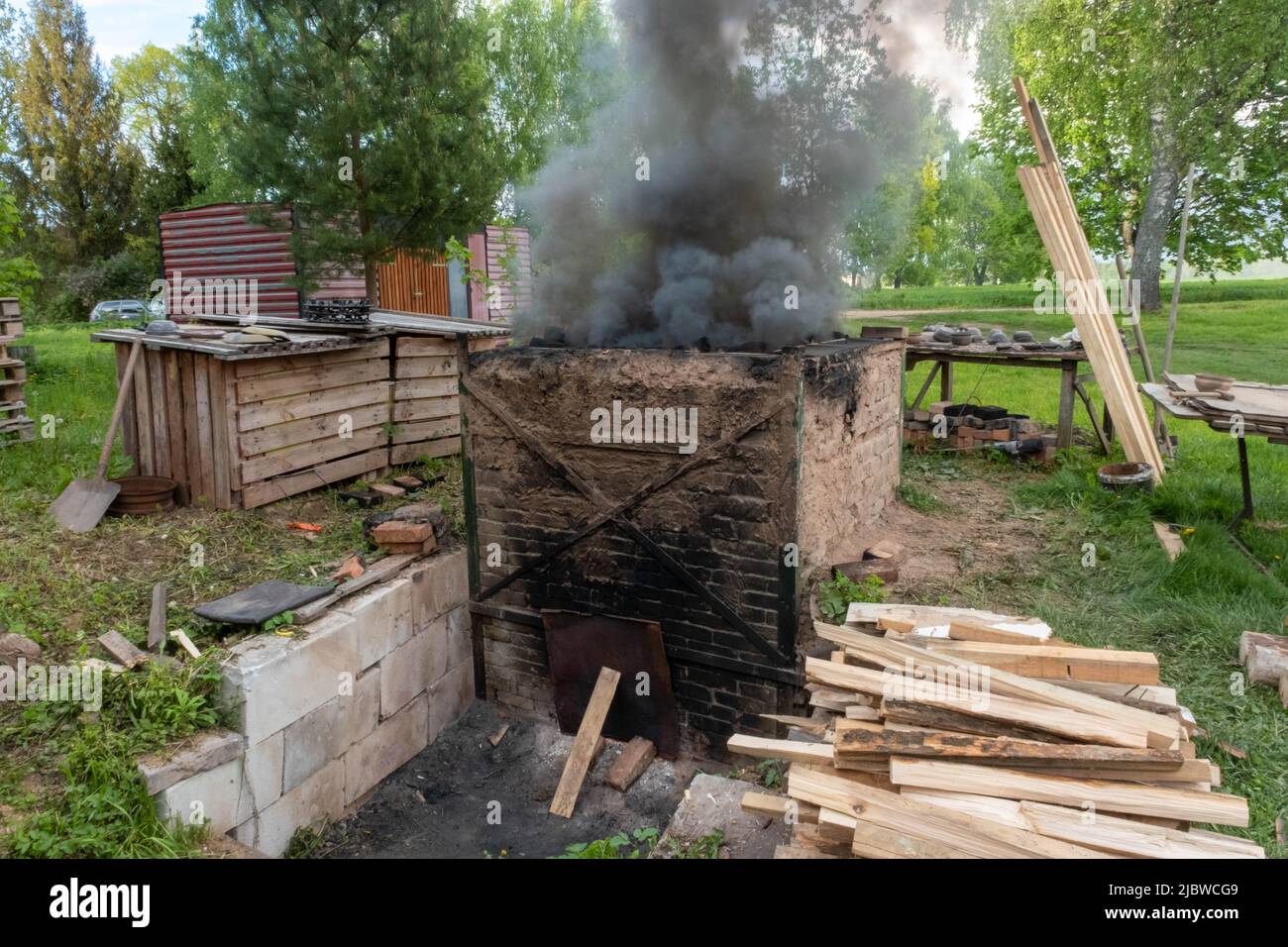 Firing of wood fire kiln is part of process for black pottery. Unique ...