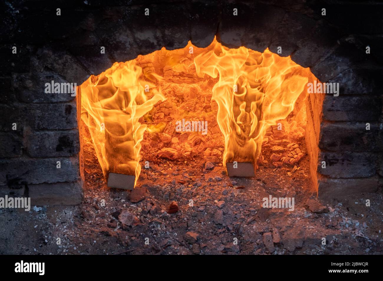 Firing of wood fire kiln is part of process for black pottery. Unique ...
