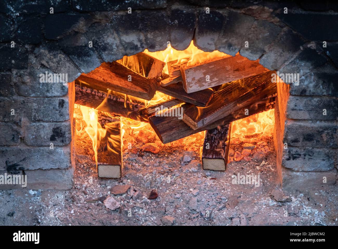 Firing of wood fire kiln is part of process for black pottery. Unique