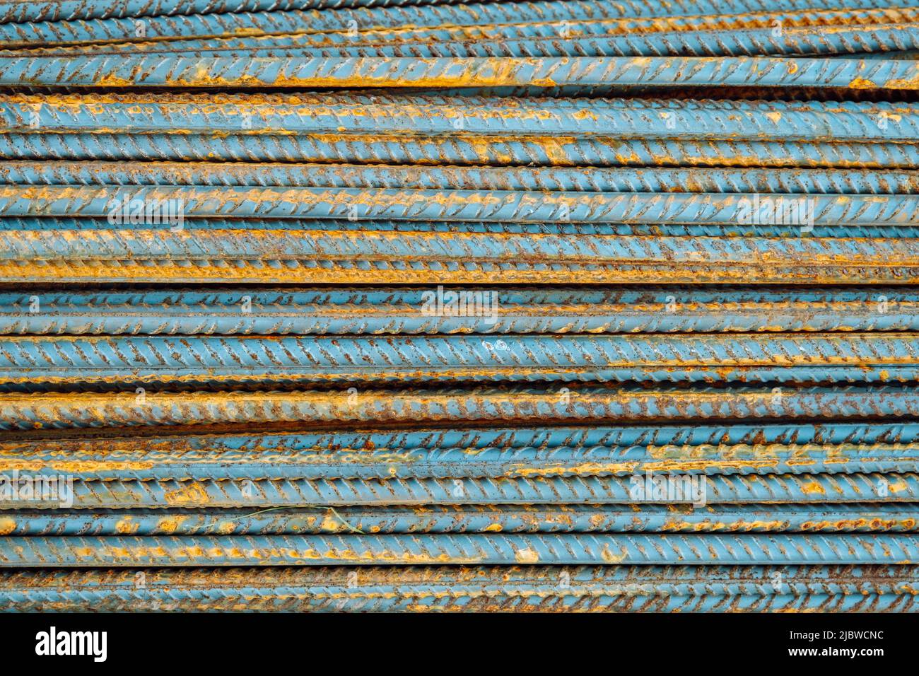 Metal fittings for reinforced concrete. Main construction materials. Background and rusty iron reinforcement rods. Red orange color of iron oxide on r Stock Photo