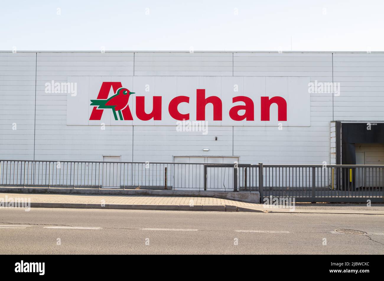 Auchan French supermarket logo. Shopping mall center, hypermarket emblem sign in Krakow, Poland. Stock Photo