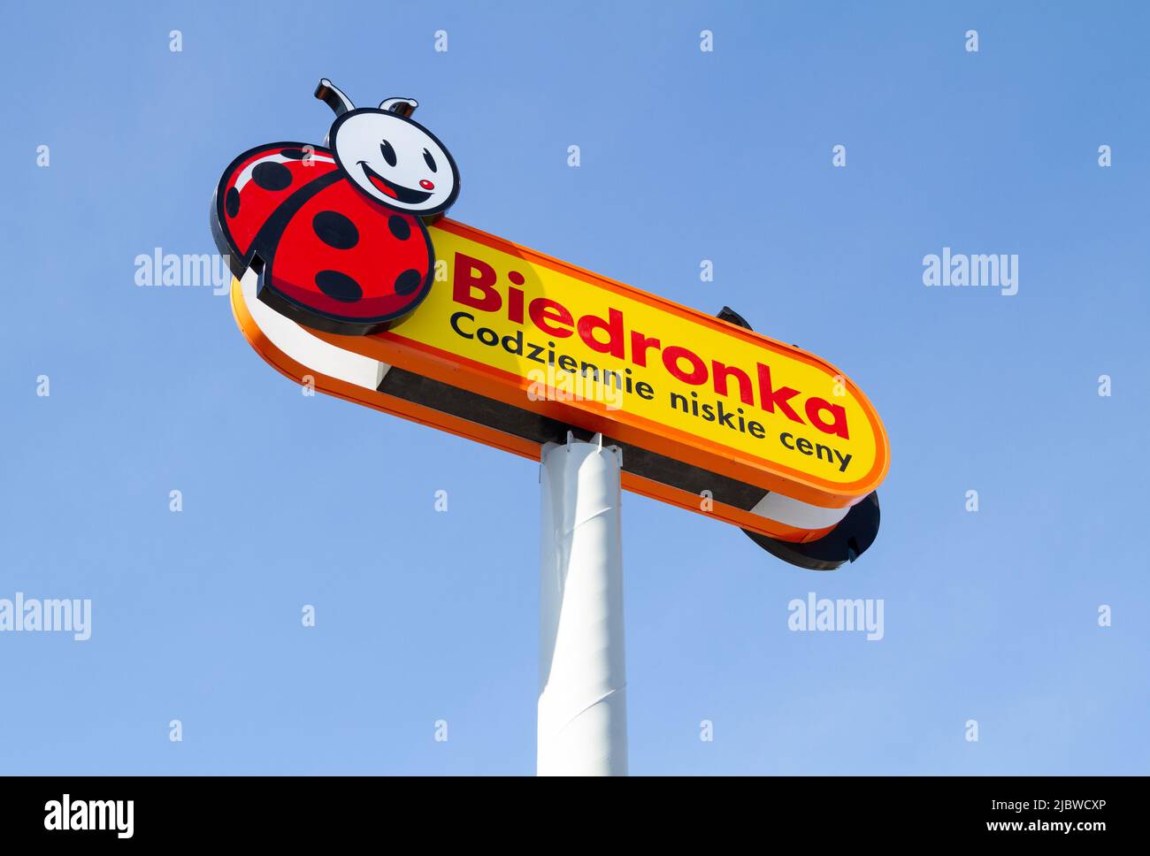 Biedronka is a retail chain of discount shops in Poland. Convenience grocery store, Polish shopping center. Signboard with brand logotype. Stock Photo