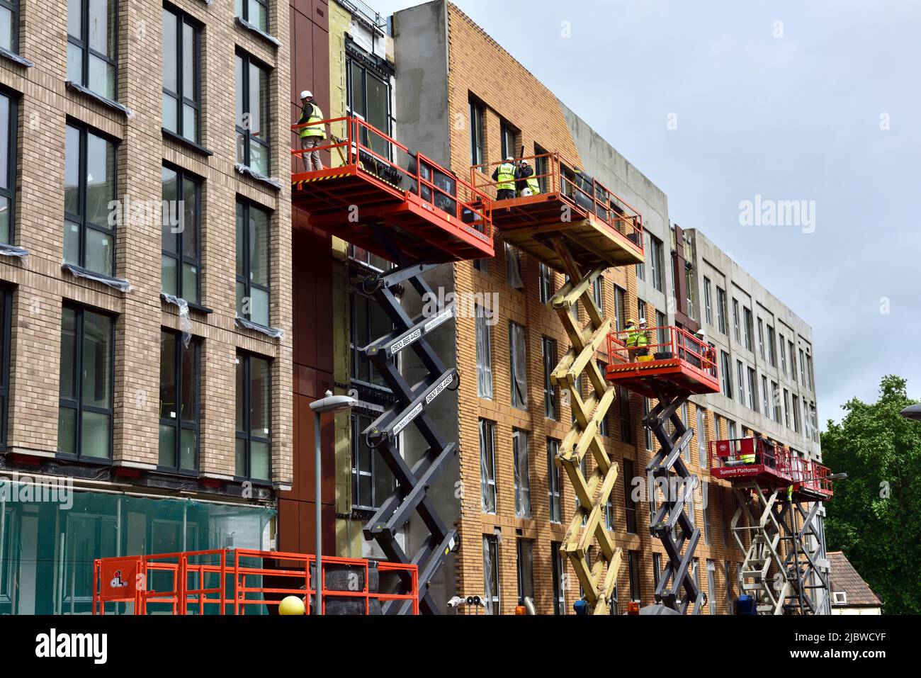 Walls of building which have external insulation board having brick slips cladding to give appearance of a brick wall, UK, student accommodation Stock Photo