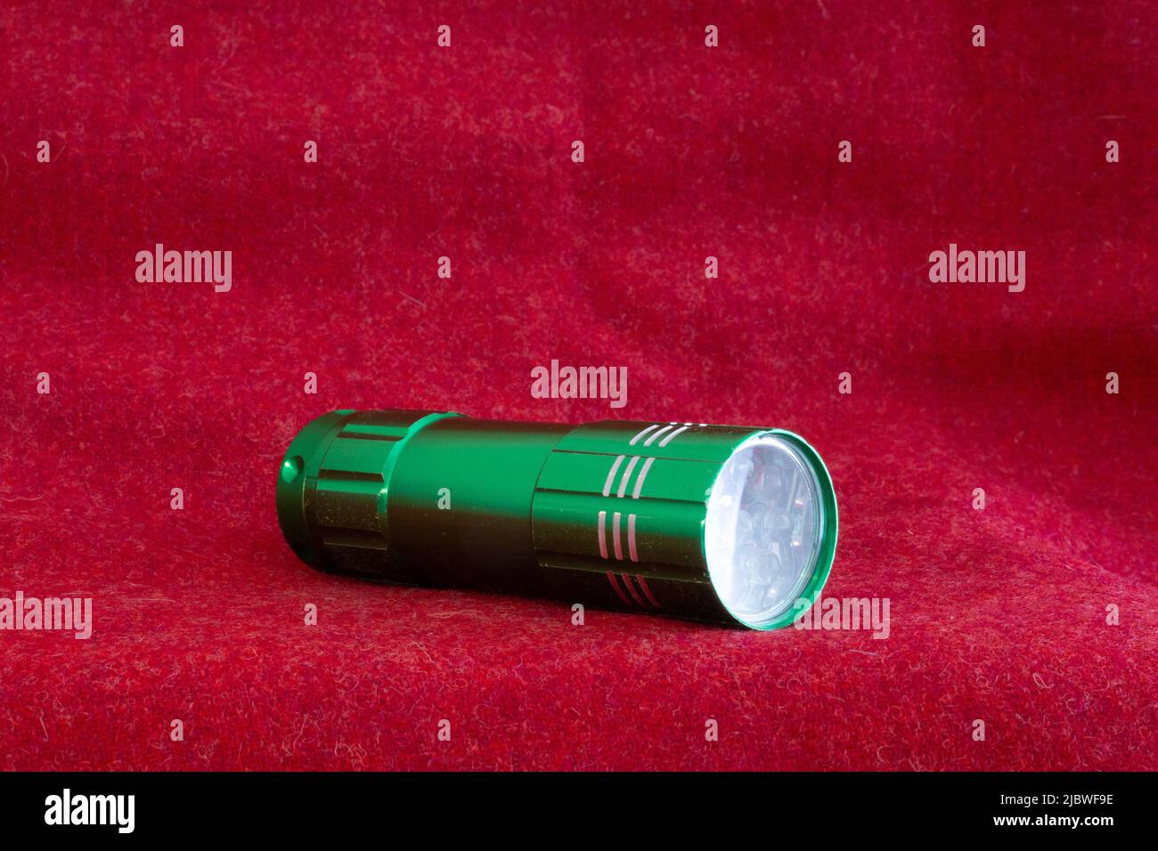 green torch on red cloth Stock Photo