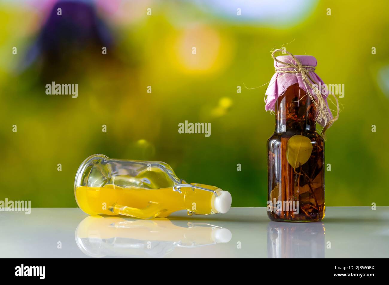herbs in decorative bottles, preserved spices, marinade, and vegetable oils in decorative bottles, culinary photography Stock Photo