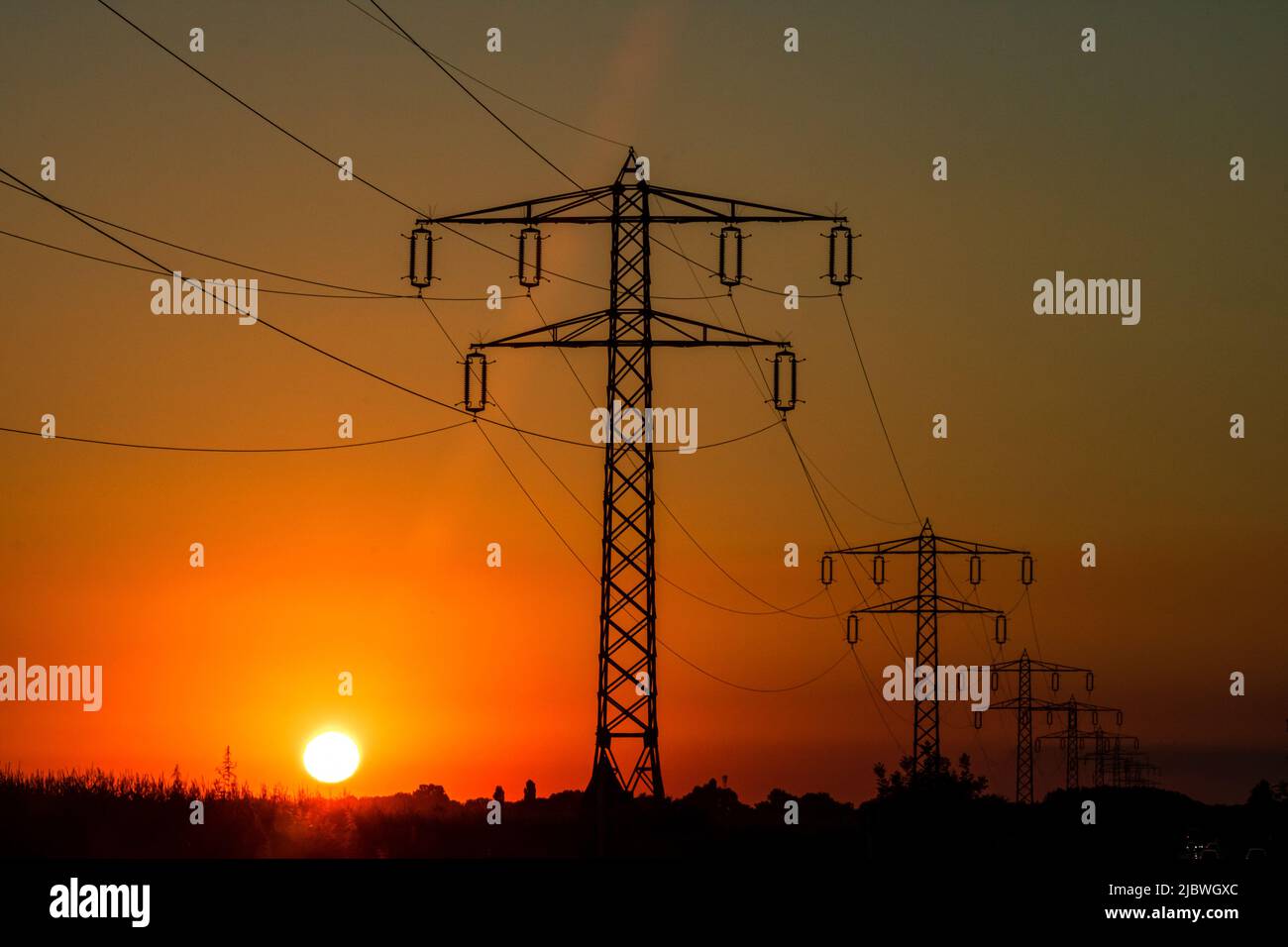 Electric power pylon, electric tower at sunset Stock Photo - Alamy