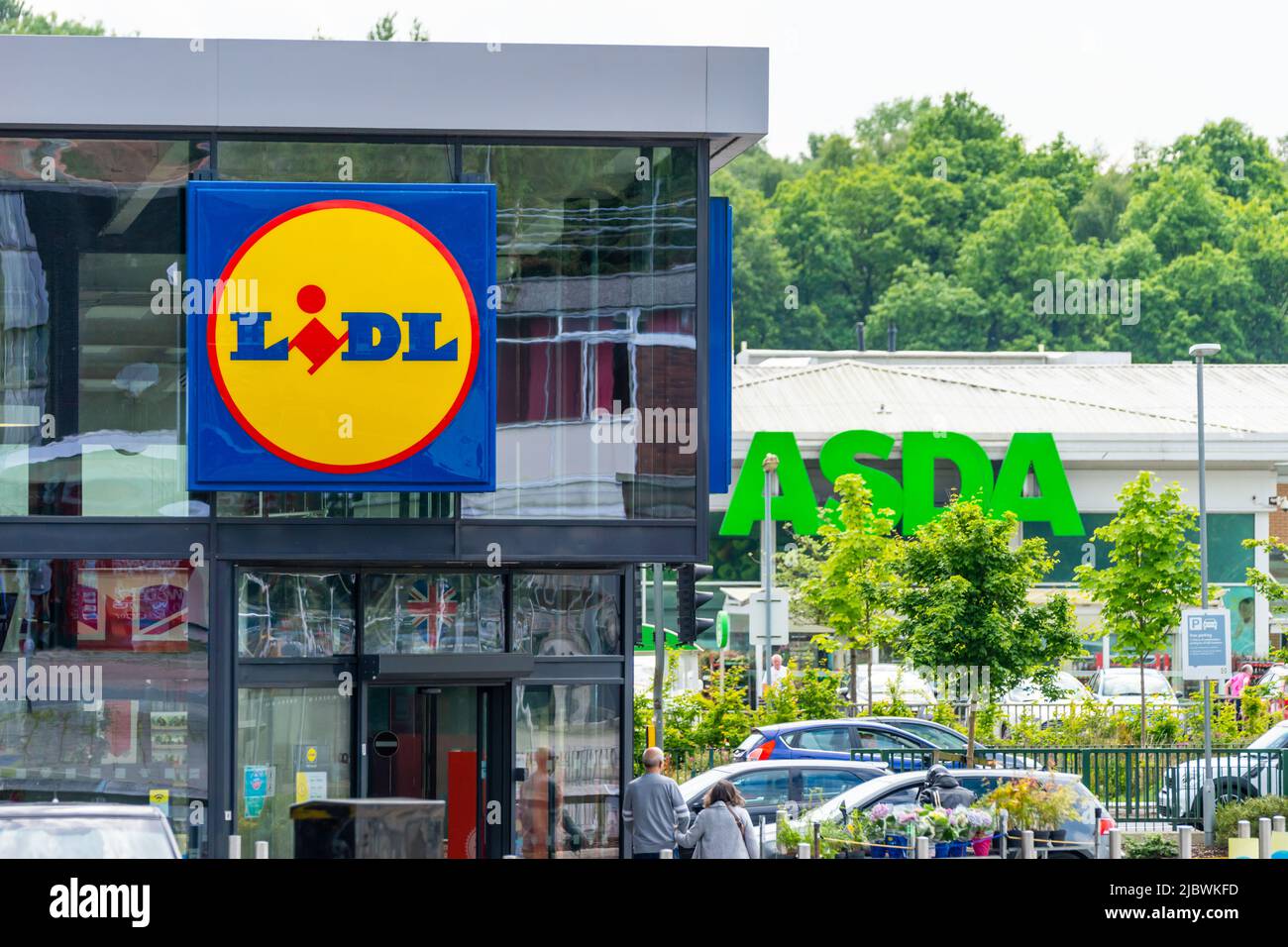 LIDL storefront, shopfront or facade with ASDA sign behind it in background. Budget supermarket, competition, rising cost of living, 'big three'. UK Stock Photo