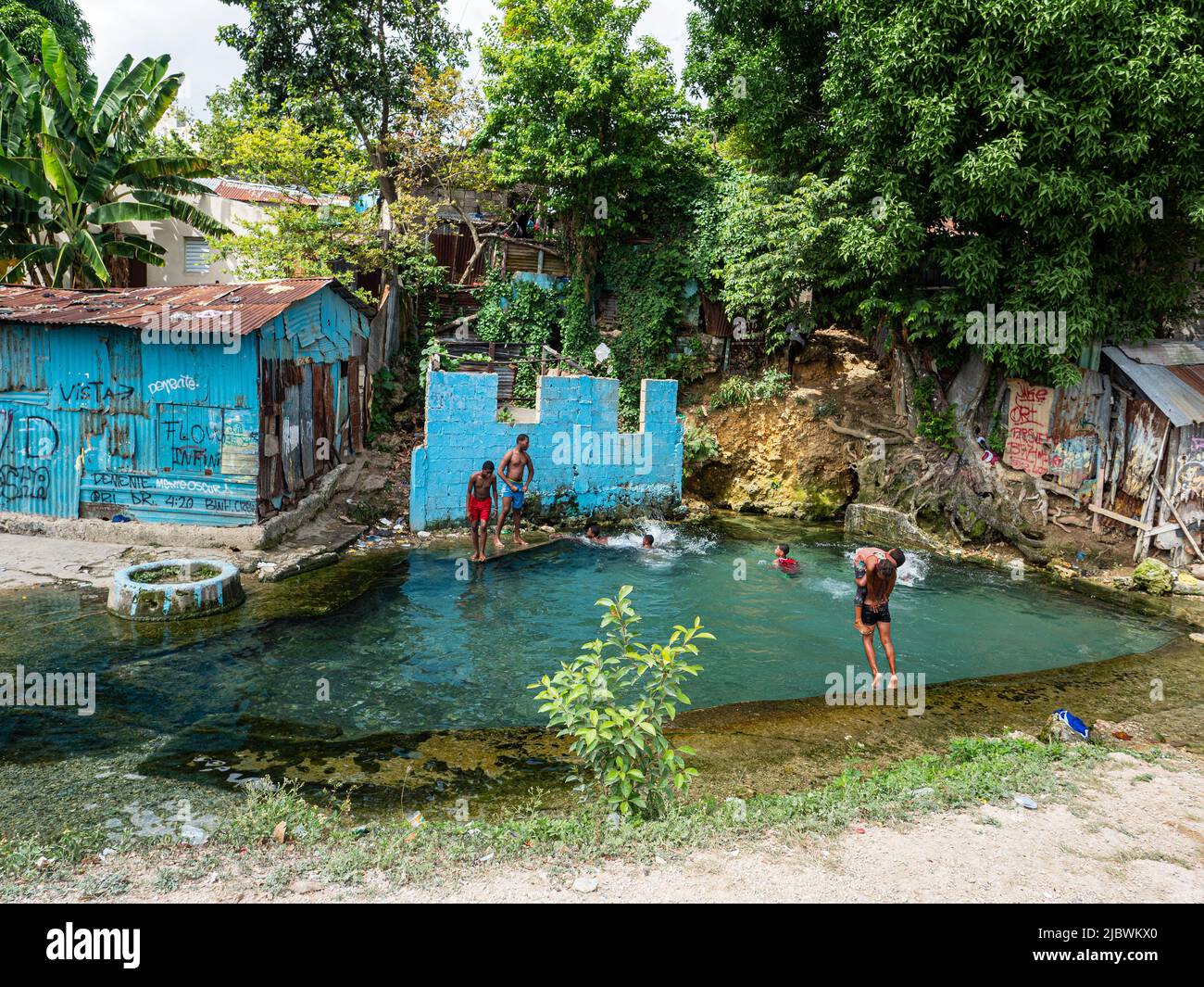 Favelas GUALEY in Santo Domingo city. Children swim in the natural pool of the most dangerous favelas in Santo Domingo city. Stock Photo
