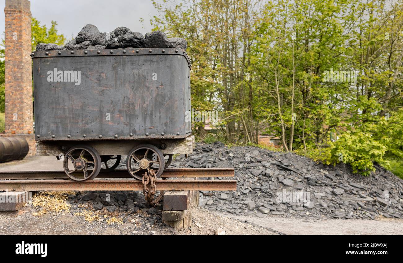 vintage coal truck on rails filled with black coal Stock Photo