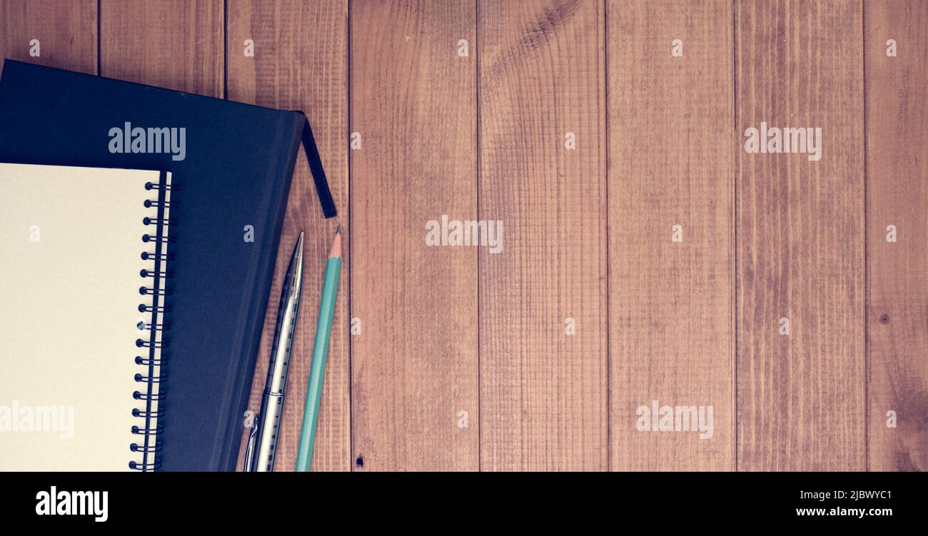 Notepad Pen And Pencil On A Wooden Desk Panorama Of Typical Office notepad-pen-and-pencil-on-a-wooden-desk-panorama-of-typical-office