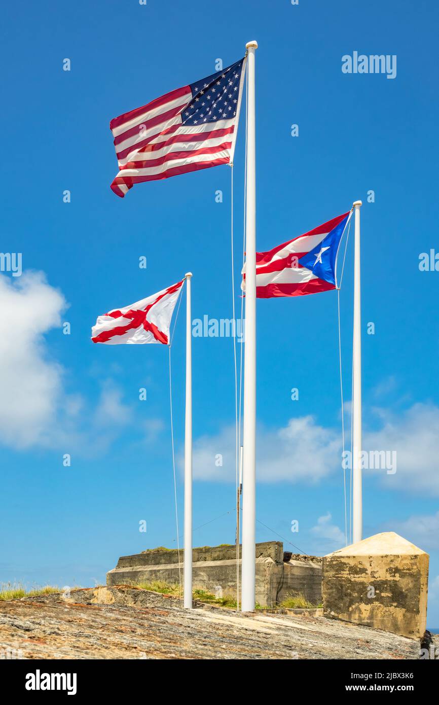 Flags of the USA, Puerto Rico and the historic Spanish Empire in El Morro castle in San Juan, Puerto Rico. Stock Photo