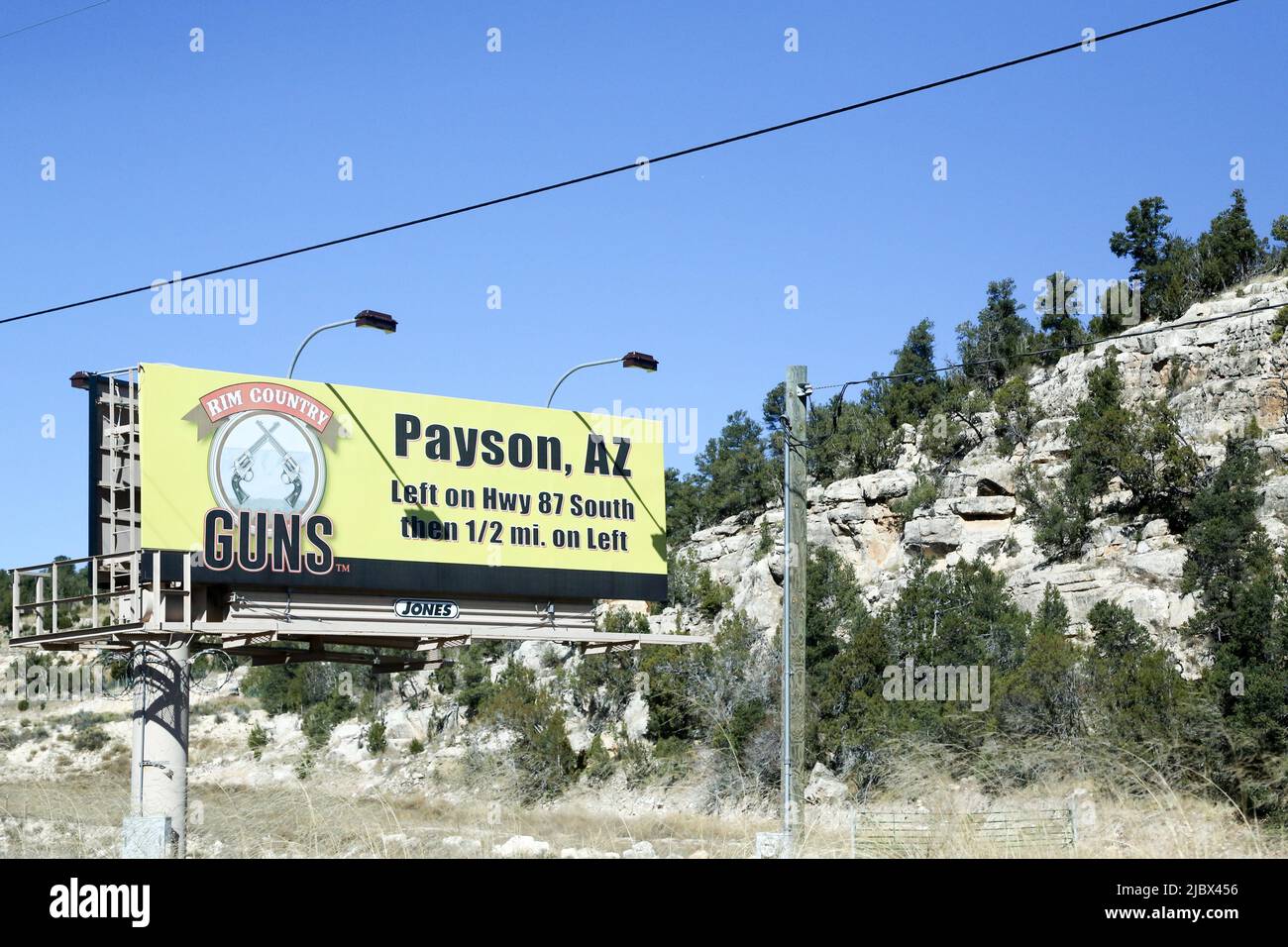 A sign advertising a gun store is seen off I40 in near Payson, Arizona
