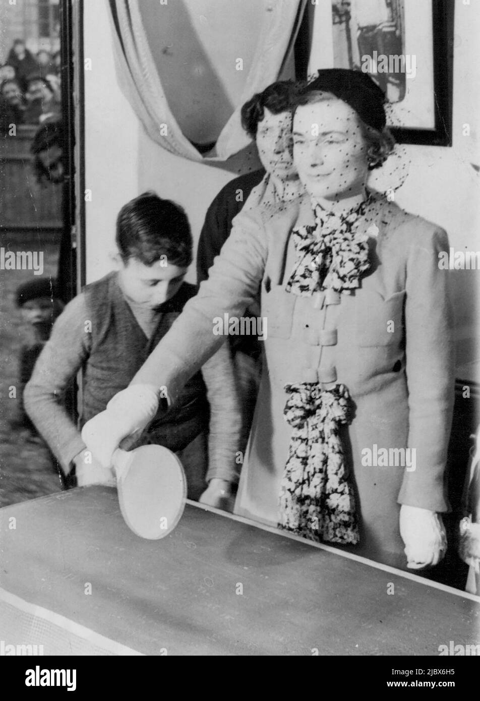 Duchess Of Gloucester Plays Ping Pong: The Duchess of Gloucester playing ping pong, in one of the new flats. The Duchess of Gloucester this afternoon opened 36 flats and 18 cottages at, Prince Regent-lane, Custom House, E., built by the Church Army House Ltd. for rehousing overcrowded families. April 07, 1937. (Photo by Keystone) Stock Photo