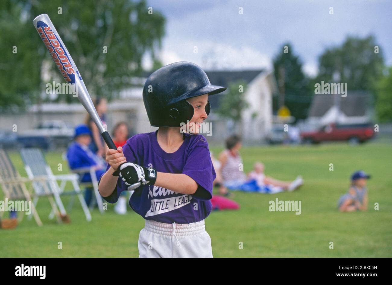 Young children play girls and boys Little League Softball at a school field in Redmond, Oregon. Stock Photo