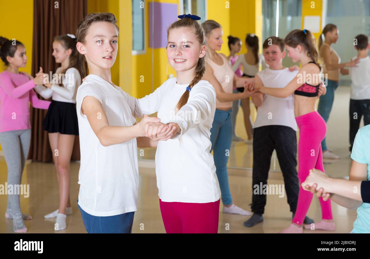 Tweens training slow foxtrot in dance studio Stock Photo