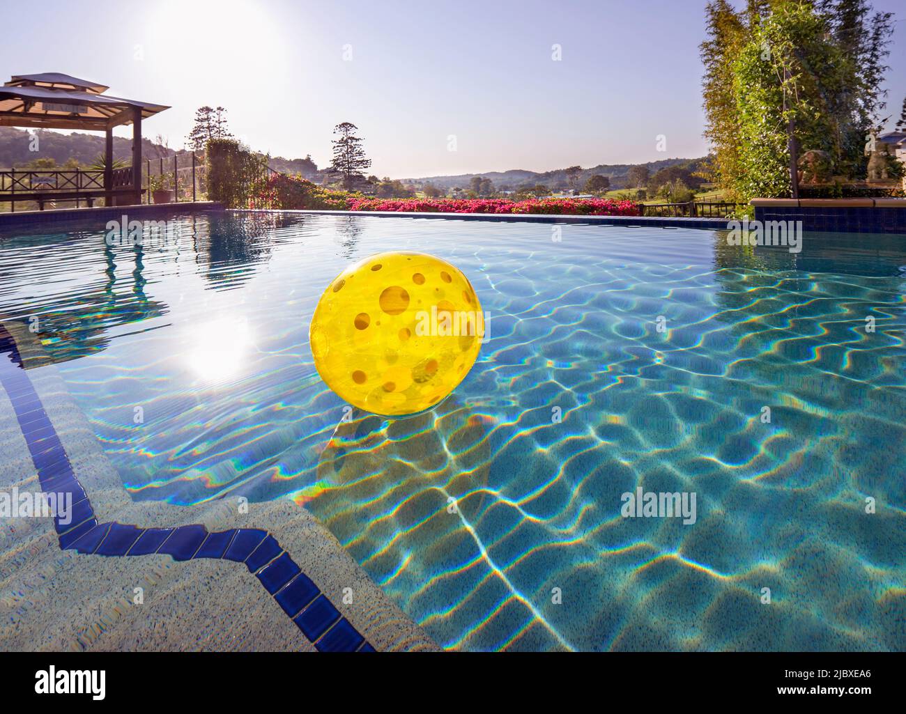 Inflatable ball floating in swimming pool Stock Photo