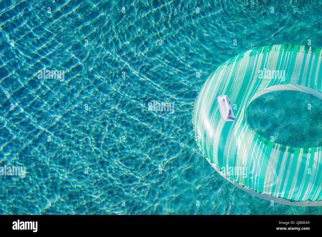 Inflatable ring floating on water in swimming pool Stock Photo