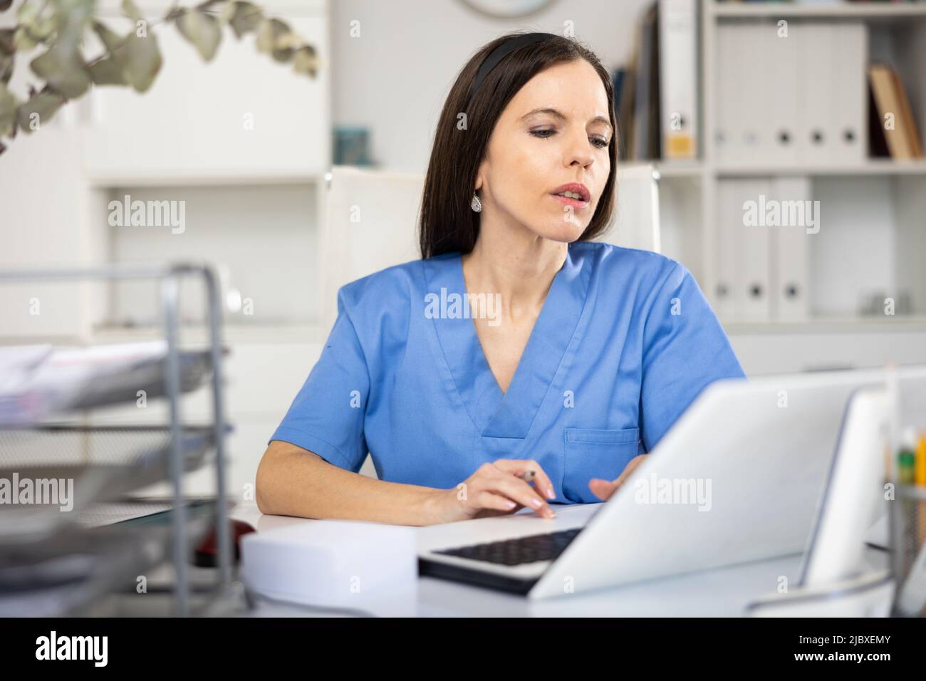 Portrait of female doctor using laptop in office Stock Photo