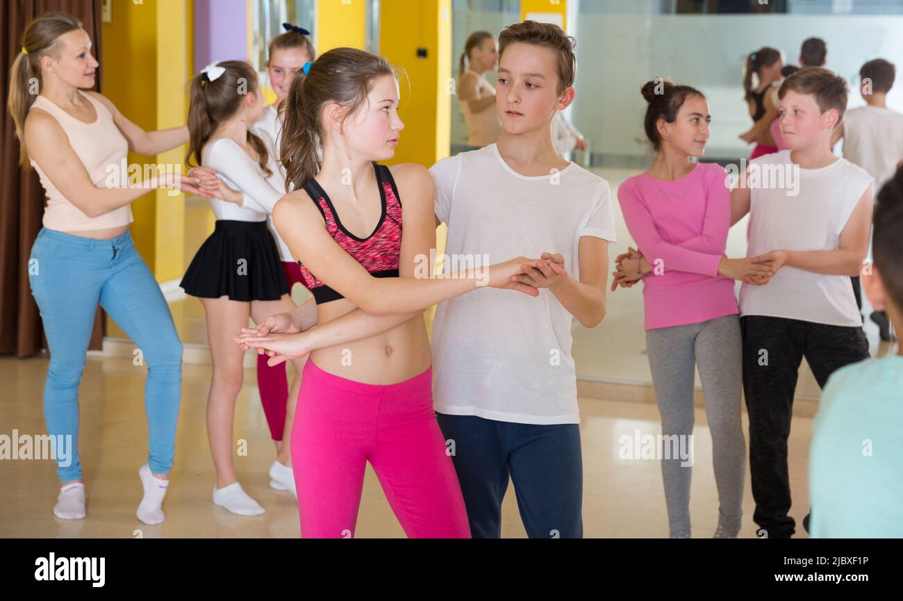 Teenagers in pairs learning active boogie-woogie Stock Photo
