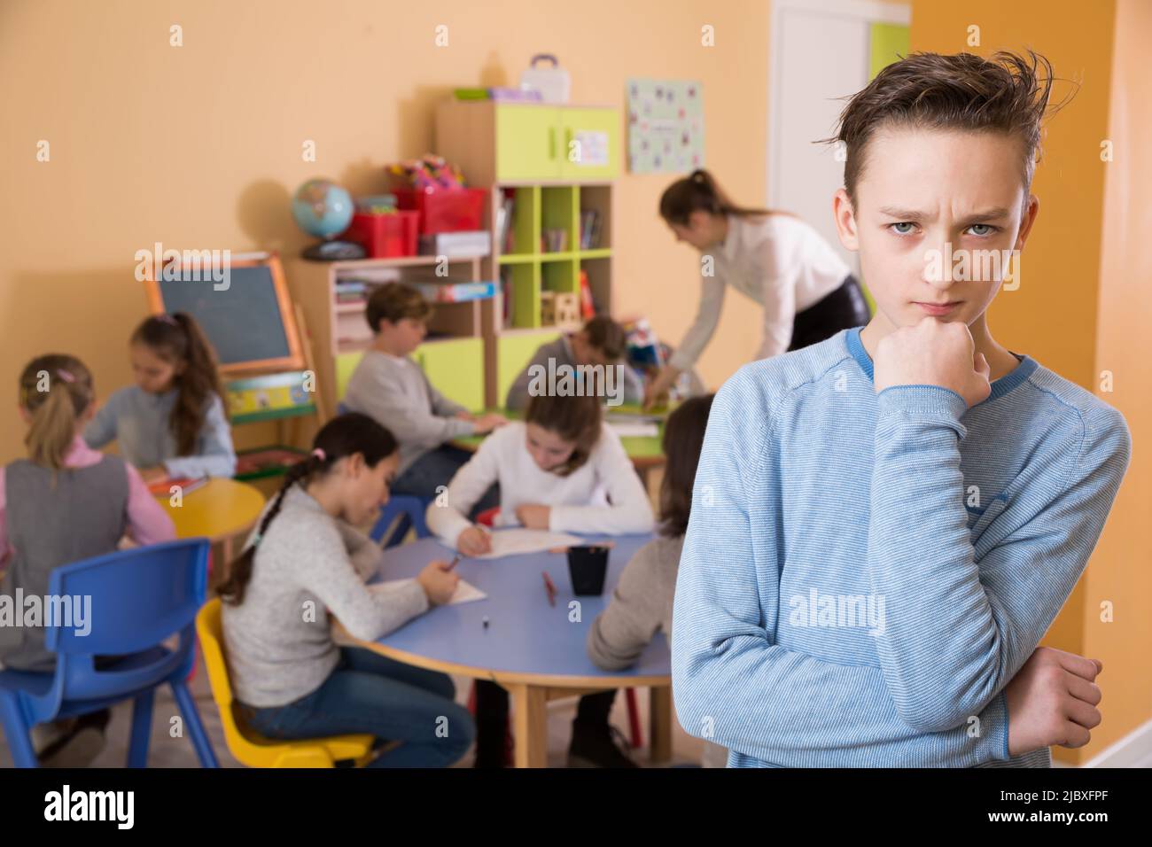 Portrait of sad schoolboy and children drawing Stock Photo