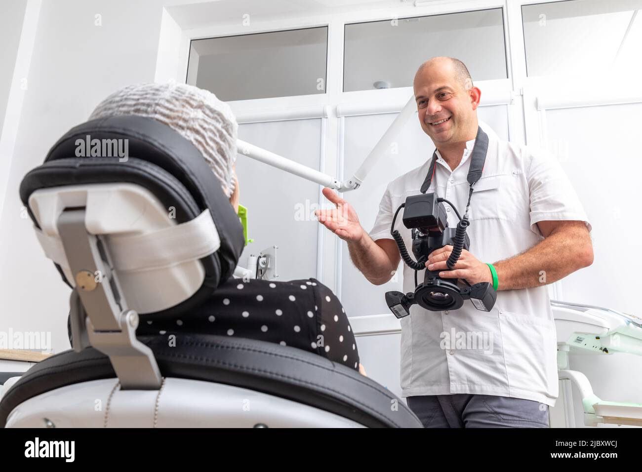 Dentist photographing patient's teeth for medical record before and after surgery in dentist