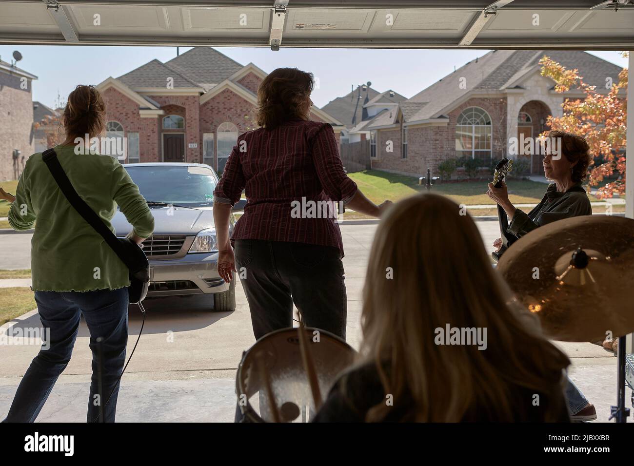 Garage band composed of middle aged women, practicing in residential