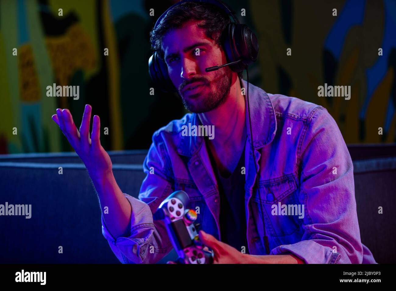 Gamer making a frustrated expression at TV while playing at home in