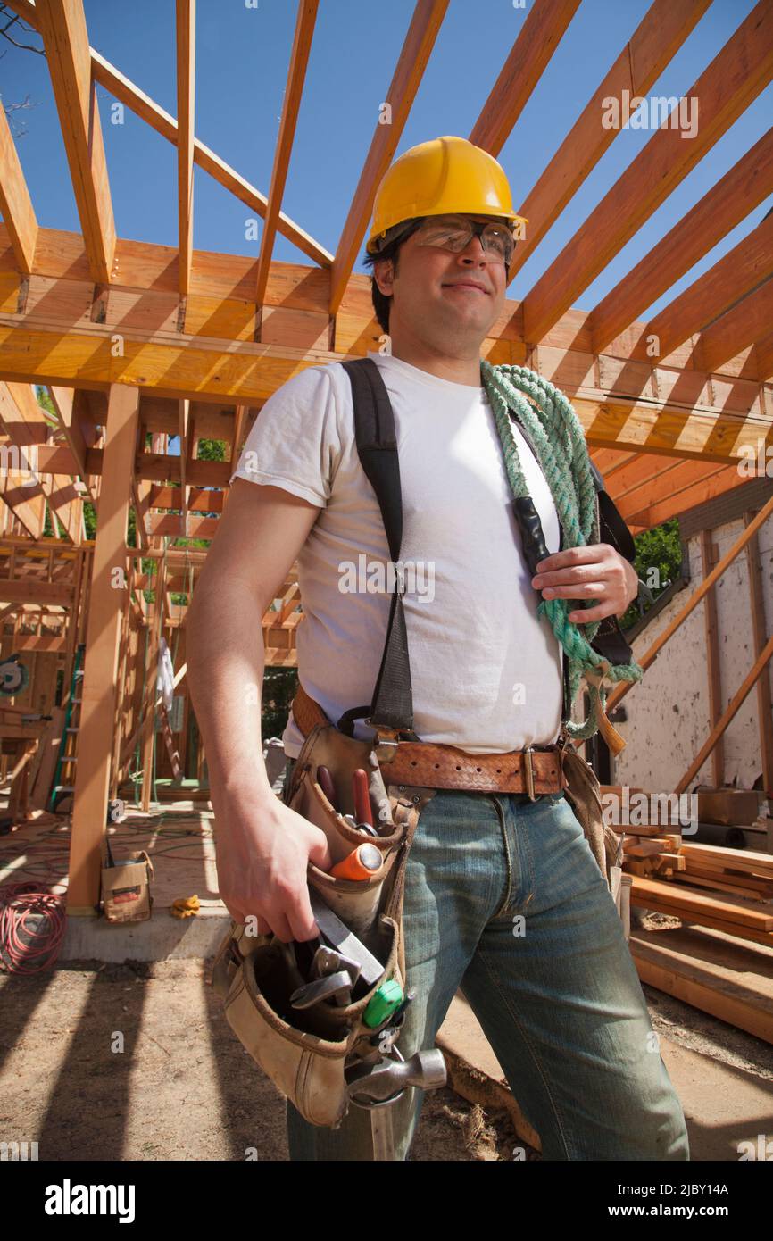Portrait of a construction worker wearing a hard hat and a tool belt